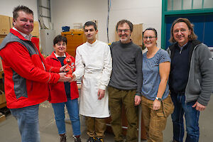 Übergabe der Räucherfigur durch Beschäftigte und Klient des ZAB an das DRK